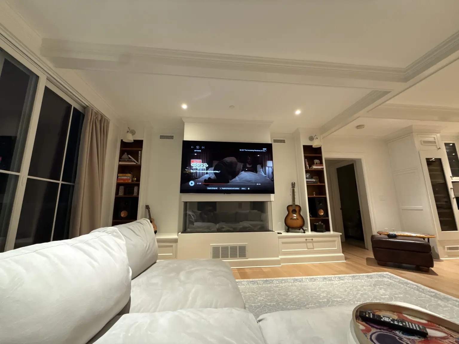 Completed living room with integrated television, speakers and fireplace
