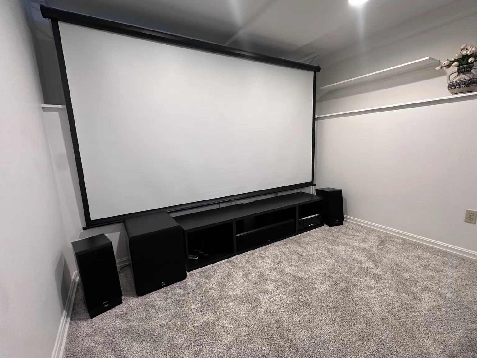 Completed dedicated home theater with projection screen and surround speakers